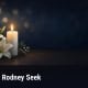Fostoria News Memorial candle and lilies for Rodney Seek obituary in Fostoria.